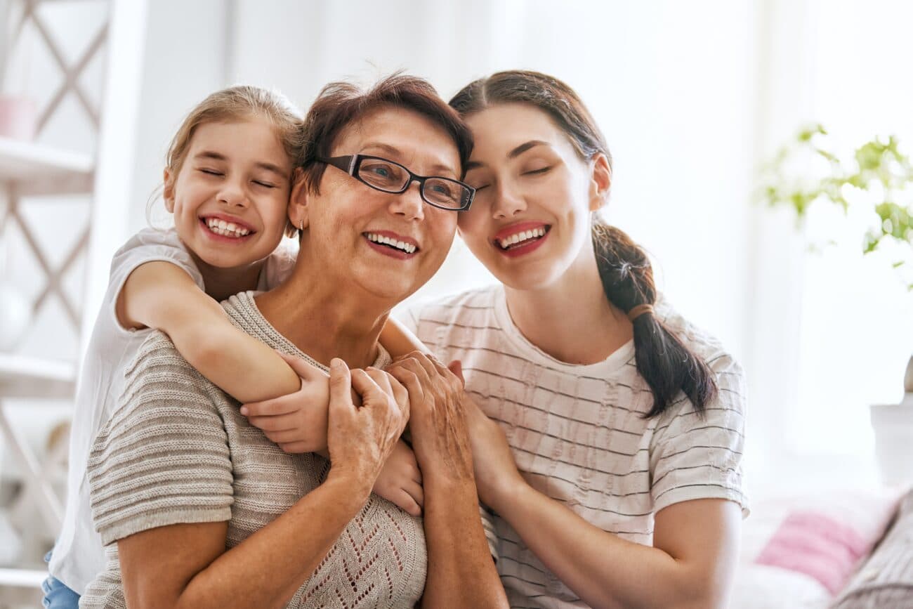 A grandmother, mother and daughter smiling together — the CDCP covers all ages