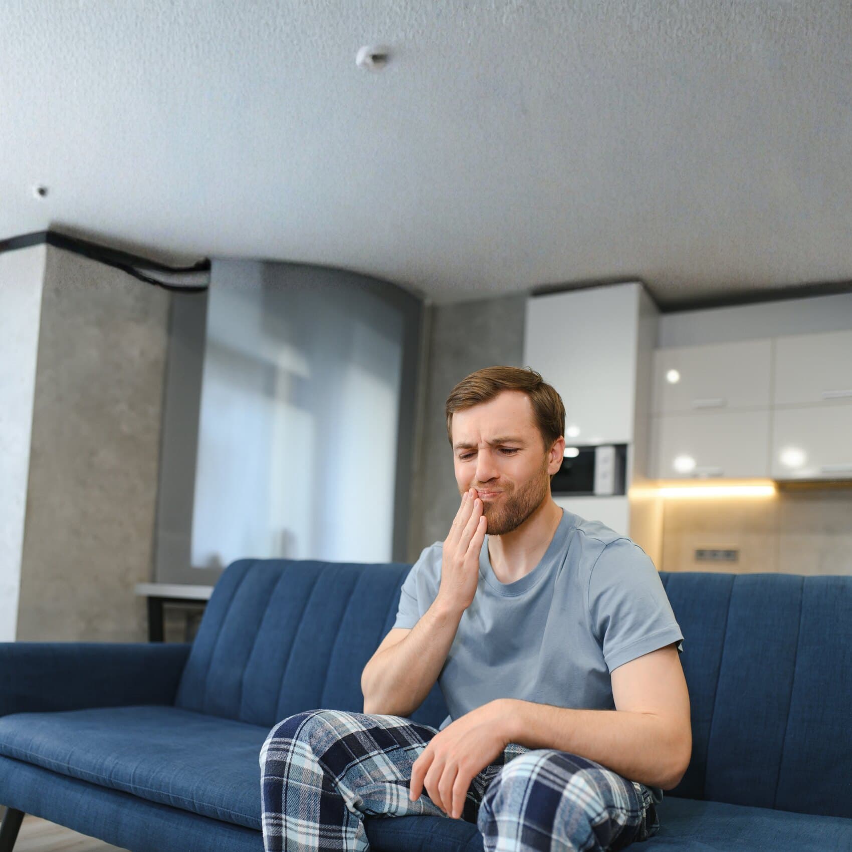 A man with tooth pain in need of urgent dental care
